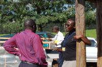 Susan Nduati, marketing specialist for the WOCCU-USDA program in Kenya, talks with fellow colleague, John Inganga, at the Finlays estates in Kericho, Kenya. Susan has worked closely with John and the rest of WOCCU’s agriculture team to identify proper crops and markets for farmers, caregiver groups and people living with HIV/AIDS.