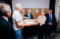 CAP Project Chief of Party Ewa Sierzynska presents a laptop from USAID